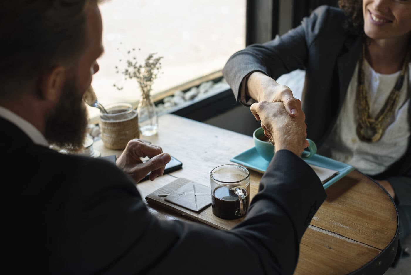 Two colleagues reviewing documents across a meeting table