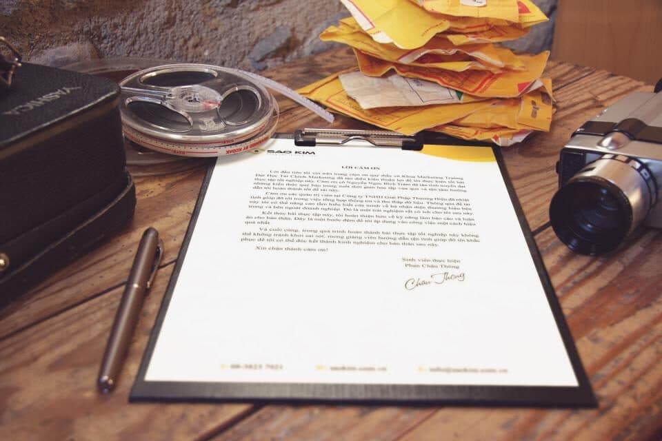 A printed document on a clipboard with a pen