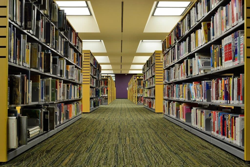 A long aisle of archive shelving stacked with records
