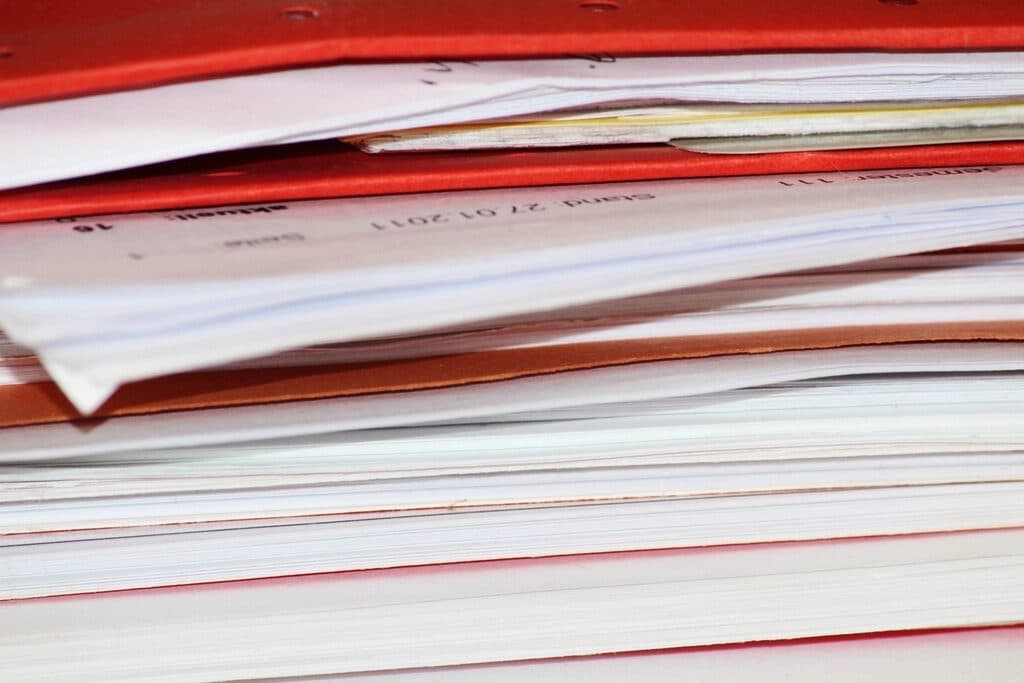 A stack of paper documents awaiting scanning
